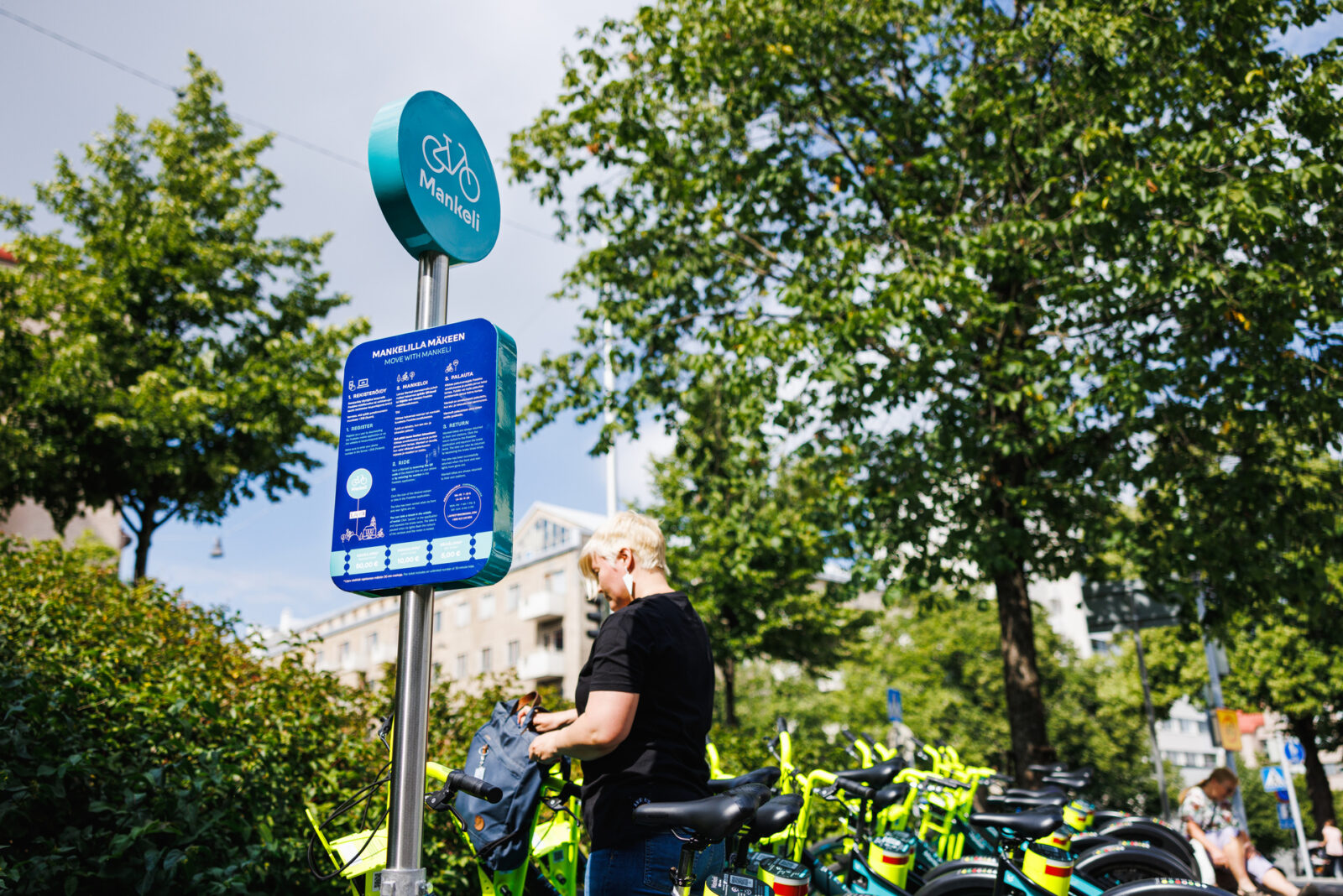 Mankeli-aseman kyltti vehreässä ympäristössä.