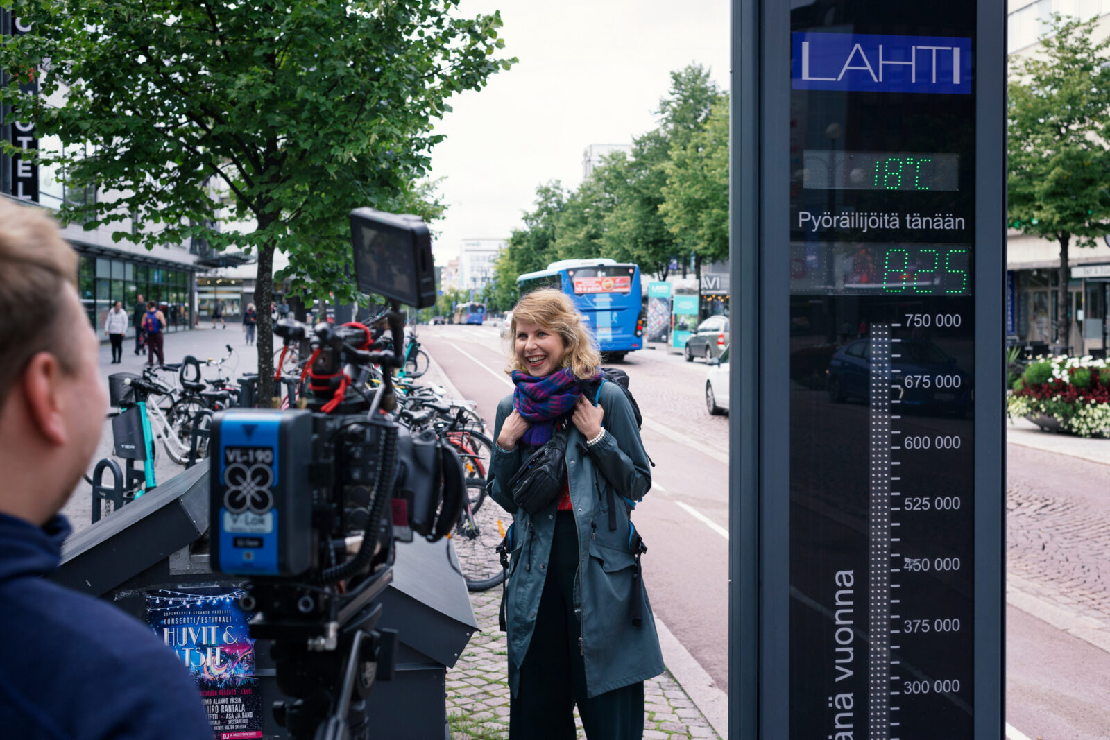 Anna Huttunen is giving an interview next to the counter that measures the number of cyclists